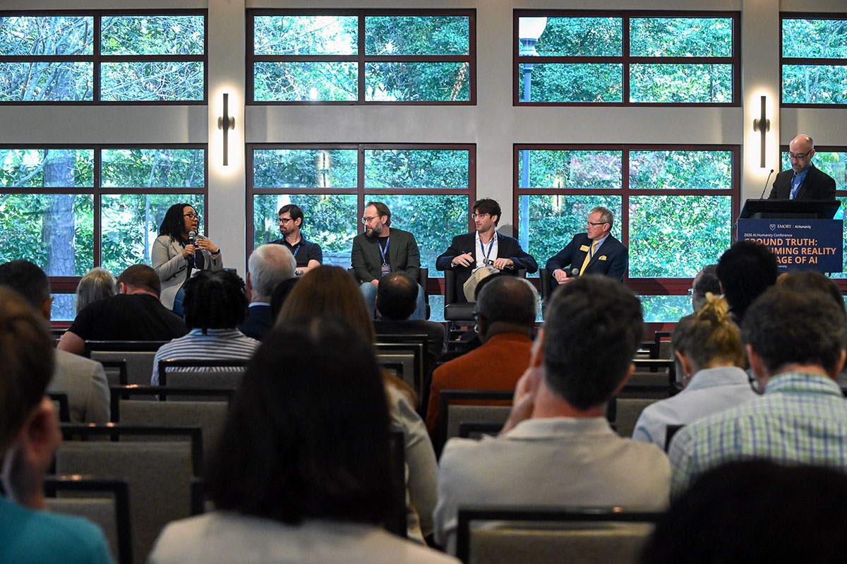 Four panelists with audience in foreground