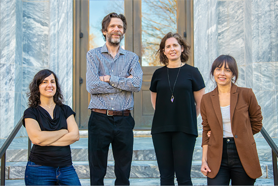 Four faculty standing on marble steps