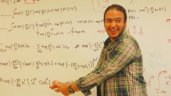 Eslam Abdelaleem in front of white board with figures