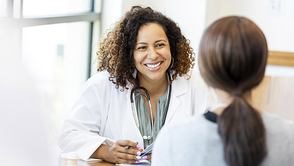 Female doctor speaks with patient